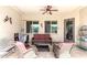 Relaxing covered patio featuring comfortable seating, a ceiling fan, and neutral color palette at 18543 W Denton Ave, Litchfield Park, AZ 85340