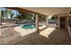Covered patio overlooking inground pool, rock features and lush landscaping in a spacious backyard at 2009 N 125Th Ave, Avondale, AZ 85392