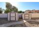 Backyard featuring two storage sheds, desert landscaping, and privacy fence at 2009 N 125Th Ave, Avondale, AZ 85392