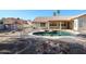 Landscaped backyard with unique pool design, rock accents, and convenient storage shed at 2009 N 125Th Ave, Avondale, AZ 85392
