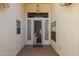 Covered front entryway featuring a decorated security door with a hanging light fixture at 2009 N 125Th Ave, Avondale, AZ 85392