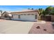 View of the garage with three car spaces and decorated with some stone accents at 2009 N 125Th Ave, Avondale, AZ 85392