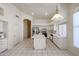 Bright kitchen with island, tiled floors, stainless appliances, and views of the living area at 2009 N 125Th Ave, Avondale, AZ 85392