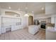 Spacious eat-in kitchen features tiled floors, white cabinetry, a kitchen island and recessed lighting at 2009 N 125Th Ave, Avondale, AZ 85392