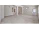 Spacious living area with plush carpeting, arched details, and ample natural light at 2009 N 125Th Ave, Avondale, AZ 85392