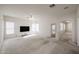 Bright living room with natural light, ceiling fan, and neutral carpet at 2009 N 125Th Ave, Avondale, AZ 85392