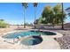 Backyard pool and spa with rock details, mature trees, and desert landscaping at 2009 N 125Th Ave, Avondale, AZ 85392