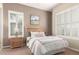 Cozy bedroom with neutral paint, plantation shutters, and comfortable furnishings at 20802 N Grayhawk Dr # 1005, Scottsdale, AZ 85255