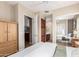 Bright bedroom with neutral walls, ceiling fan and ensuite bathroom at 20802 N Grayhawk Dr # 1005, Scottsdale, AZ 85255