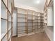 Spacious walk-in closet with custom shelving providing ample storage and organization solutions at 20802 N Grayhawk Dr # 1005, Scottsdale, AZ 85255