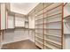 Spacious walk-in closet featuring custom shelving and ample storage for clothing and accessories at 20802 N Grayhawk Dr # 1005, Scottsdale, AZ 85255