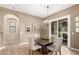 Elegant dining room featuring a granite table, stylish chairs, and a modern chandelier at 20802 N Grayhawk Dr # 1005, Scottsdale, AZ 85255