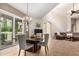 Open dining area featuring a marble table, neutral chairs, and seamlessly flows into the living area at 20802 N Grayhawk Dr # 1005, Scottsdale, AZ 85255