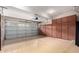 Well-organized garage with cabinets for storage and epoxy flooring, providing a clean and functional space at 20802 N Grayhawk Dr # 1005, Scottsdale, AZ 85255