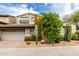 Attractive two-story home with a well-manicured front yard, a two car garage, and desert landscaping at 20802 N Grayhawk Dr # 1005, Scottsdale, AZ 85255