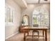Bright home office showcasing large windows with plantation shutters and a wooden desk at 20802 N Grayhawk Dr # 1005, Scottsdale, AZ 85255