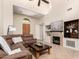 Open concept living room with a fireplace, large tv, tile floors, and comfortable seating at 20802 N Grayhawk Dr # 1005, Scottsdale, AZ 85255