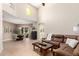 Spacious living room featuring high ceilings, tile floors, and a comfortable brown sectional sofa at 20802 N Grayhawk Dr # 1005, Scottsdale, AZ 85255