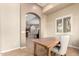Cozy study area with a wood desk, chair, and view of the living spaces at 20802 N Grayhawk Dr # 1005, Scottsdale, AZ 85255