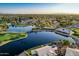 Stunning aerial view showcasing a lakeside community with lush landscaping, a golf course, and serene water features at 21121 N 63Rd Dr, Glendale, AZ 85308