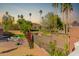 Private backyard oasis with a patio, lush greenery, and distant mountain views at 21121 N 63Rd Dr, Glendale, AZ 85308