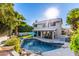 Relaxing backyard with sparkling pool, lush landscaping, and outdoor dining set at 21121 N 63Rd Dr, Glendale, AZ 85308