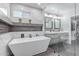 Modern bathroom features a soaking tub with glass panel and dual sinks at 21121 N 63Rd Dr, Glendale, AZ 85308