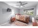 Bedroom with a bed, ceiling fan, and view of the backyard at 21121 N 63Rd Dr, Glendale, AZ 85308