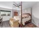 Main bedroom with a four-poster bed, ceiling fan, and wood-look floors at 21121 N 63Rd Dr, Glendale, AZ 85308