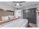 Cozy bedroom featuring a king-size bed, ceiling fan, and closet at 21121 N 63Rd Dr, Glendale, AZ 85308