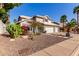 Beautiful home exterior with three-car garage and desert landscaping in a tranquil neighborhood at 21121 N 63Rd Dr, Glendale, AZ 85308