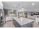 Bright kitchen with an oversized island, stainless steel appliances, and a seamless open-concept layout at 21121 N 63Rd Dr, Glendale, AZ 85308