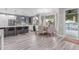 Open kitchen and dining area with gray cabinets, stainless steel appliances, a bar, and stylish lighting at 21121 N 63Rd Dr, Glendale, AZ 85308