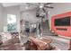Stunning living room boasts high ceilings, an open floor plan, and a cozy fireplace at 21121 N 63Rd Dr, Glendale, AZ 85308