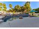 Backyard pool with a rock waterfall feature, surrounded by palm trees and desert landscaping at 21121 N 63Rd Dr, Glendale, AZ 85308