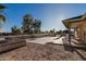 Back exterior of the home with desert landscaping and concrete patios, ideal for outdoor entertaining at 22324 W Magnolia St, Buckeye, AZ 85326