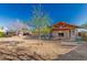 Expansive backyard with mature tree, covered patio, and room for outdoor activities and relaxation at 22324 W Magnolia St, Buckeye, AZ 85326