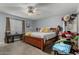 Simple bedroom with a ceiling fan, neutral walls, and a large bed at 22324 W Magnolia St, Buckeye, AZ 85326