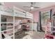 Charming pink bedroom with a loft bed, desk area, and natural light, creating a cheerful atmosphere at 22324 W Magnolia St, Buckeye, AZ 85326