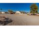 A view of the ranch home with neutral color scheme and desert landscaping on a large lot at 22324 W Magnolia St, Buckeye, AZ 85326