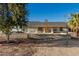 Inviting single-story home with a charming facade, quaint front porch seating, and easy desert landscaping at 22324 W Magnolia St, Buckeye, AZ 85326