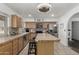Functional kitchen featuring an island, stainless steel appliances, and tile countertops at 22324 W Magnolia St, Buckeye, AZ 85326