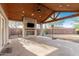 Expansive covered patio with a stone fireplace, outdoor speakers, and ceiling fan, perfect for entertaining at 22324 W Magnolia St, Buckeye, AZ 85326