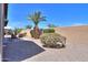 Desert landscaped backyard featuring rock ground cover, brick patio, and block wall at 2384 E Santiago Trl, Casa Grande, AZ 85194