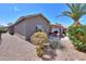 Backyard featuring desert landscaping and a covered patio with outdoor furniture at 2384 E Santiago Trl, Casa Grande, AZ 85194