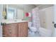 Full bathroom featuring tiled floors, oak vanity, and shower tub combo with curtain at 2384 E Santiago Trl, Casa Grande, AZ 85194