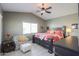 Vaulted ceilings with large bed, accent chair and ottoman in a spacious primary bedroom at 2384 E Santiago Trl, Casa Grande, AZ 85194