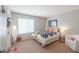 Cozy bedroom features neutral walls, carpet and a white chair at 2384 E Santiago Trl, Casa Grande, AZ 85194