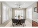 Bright dining area with stylish chairs, round table, neutral paint, and plantation shutters at 2384 E Santiago Trl, Casa Grande, AZ 85194