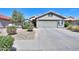 Inviting single-story home with a two car garage, desert landscaping and a tile roof at 2384 E Santiago Trl, Casa Grande, AZ 85194